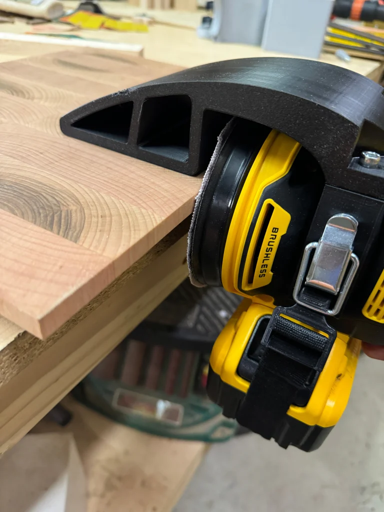 Xact90 guide on a DeWalt 20V cordless sander against a hardwood edge