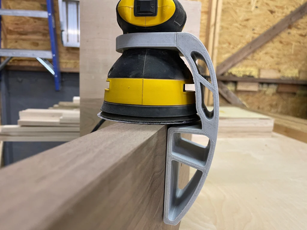 Xact90 guide holding a yellow DeWalt sander square on the edge of a walnut board