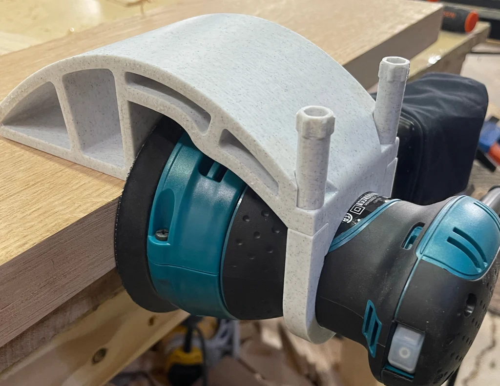 Xact90 guide mounted on a Makita sander resting on a board edge